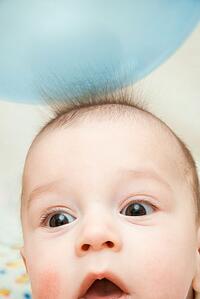 baby with static from a balloon